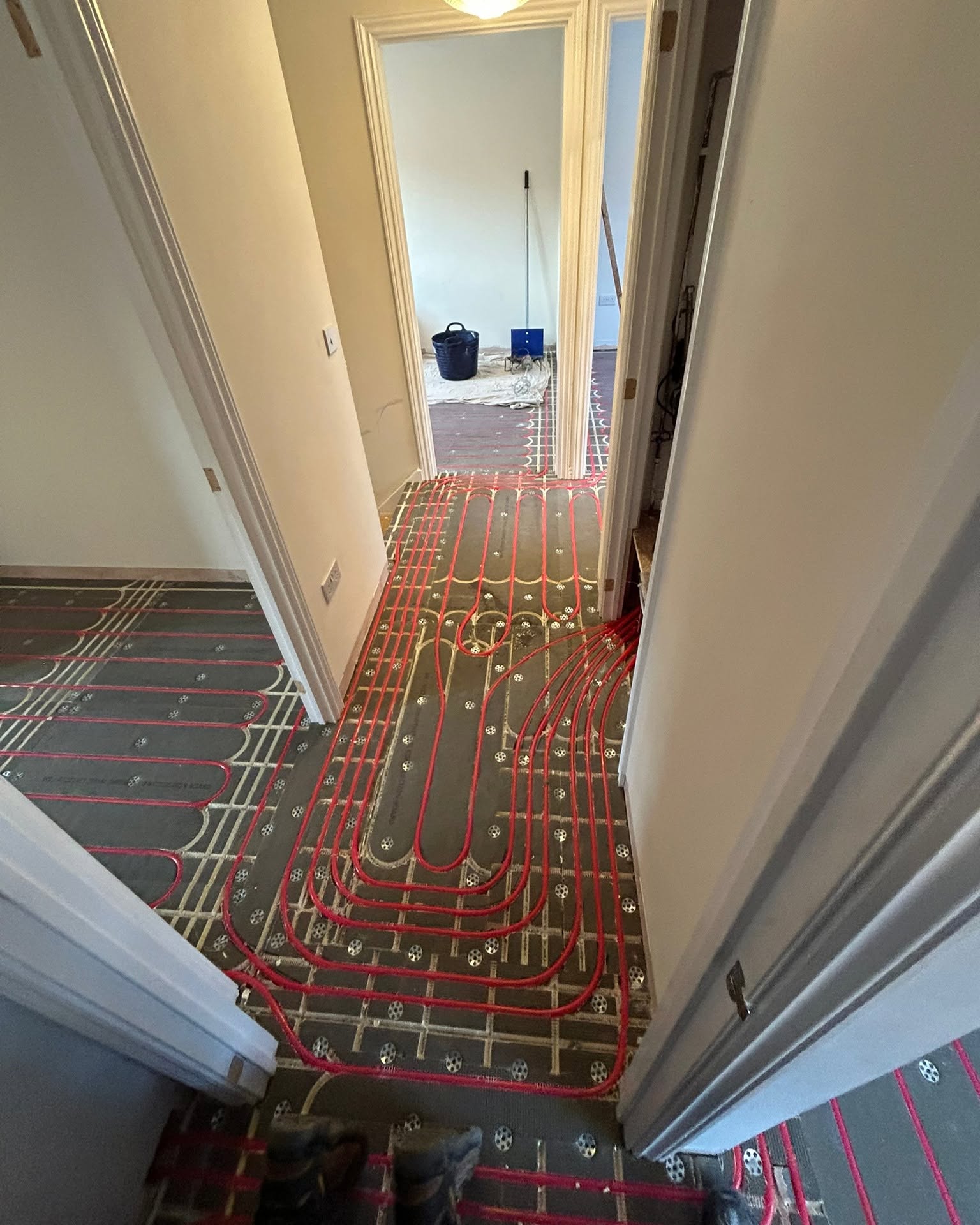 Underfloor heating pipe run through a domestic hallway in Greater Manchester