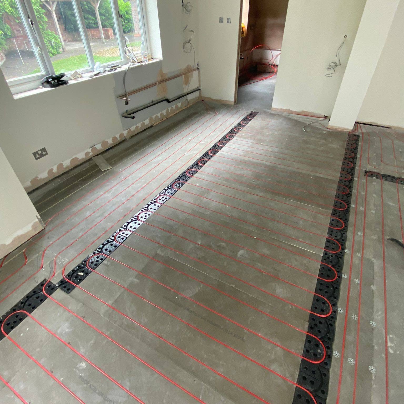 Warm-water underfloor heating loops installed in a lounge extension, Greater Manchester